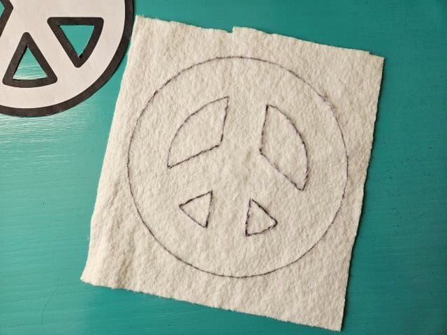 Trace the peace sign onto the batting