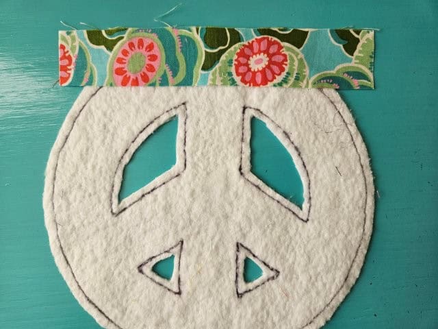 First strip of fabric on peace sign