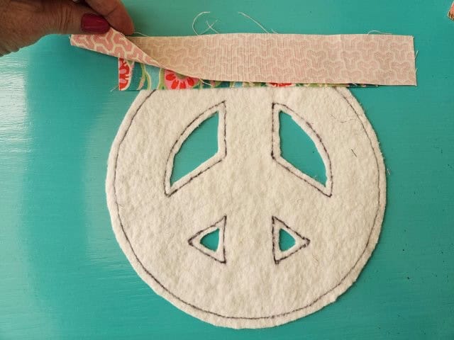 Place second strip of fabric on top of the first, right sides together