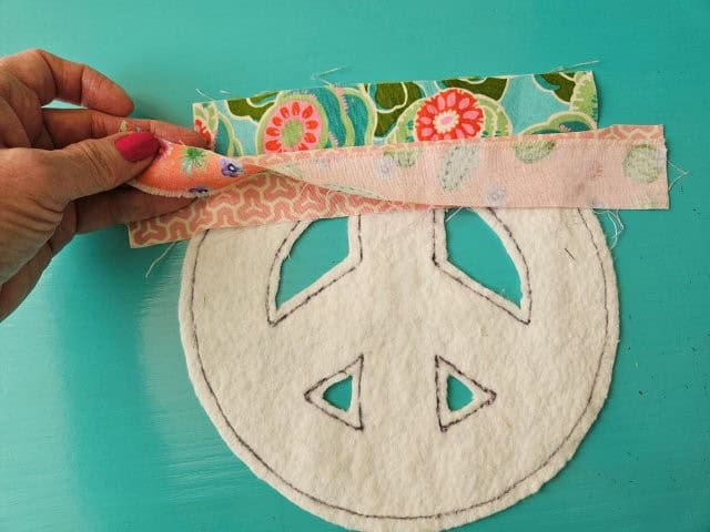 Place a third strip of fabric on top of the second